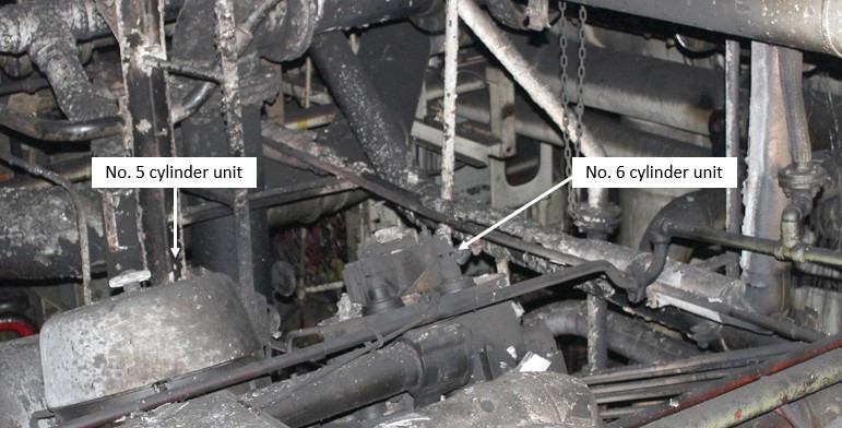 Damage to the port main engine’s No. 5 and No. 6 cylinder units and surrounding areas. The No. 6 cylinder unit cover was destroyed during the fire. (Source: TSB)