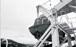 Photo 6 - After view of lifeboat, showing davit, gripe arrangement around bollards, suspension ring, hook, and hatch